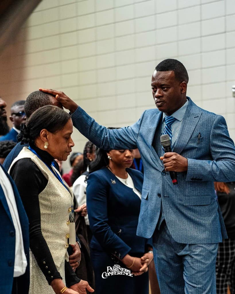 Apostolic prayer ministry moment during service.